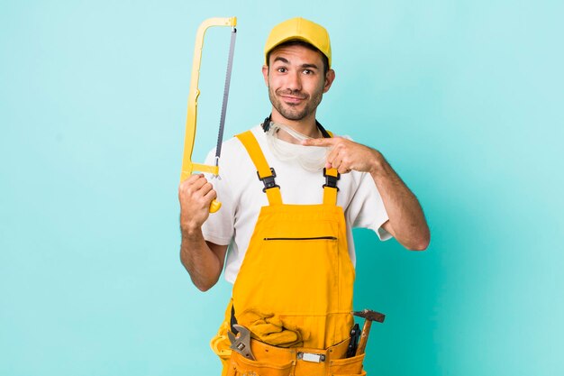 Young adult man handyman with a saw concept
