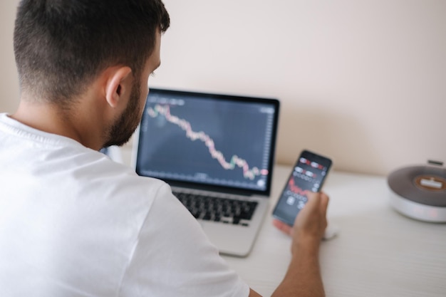 Young adult man trading on line with tablet pc connected to stock market people finance investments