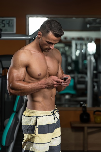 Young Adult Portrait With Mobile At The Gym