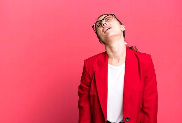 Young adult pretty businesswoman with red blazer and a copy space