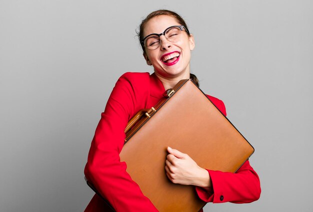 Young adult pretty businesswoman with a suitcase