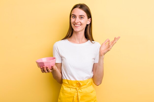 Young adult pretty chef woman with an empty bowl