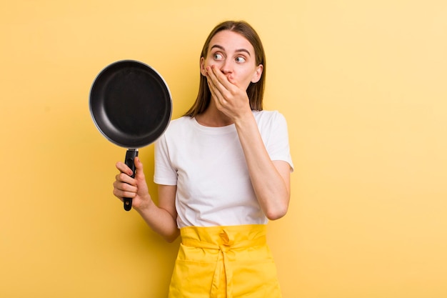 Young adult pretty chef woman with a pan