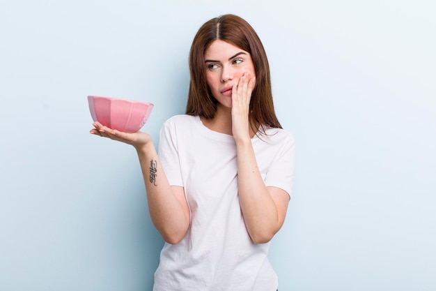 Young adult pretty woman with an empty bowl copy space