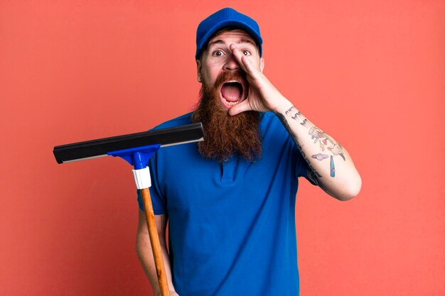 Young adult red hair bearded cool man windows washer concept