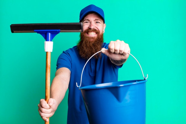 Young adult red hair bearded cool man windows washer concept