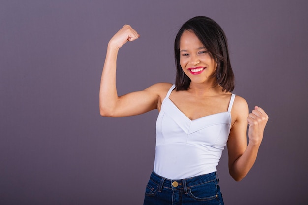 Young adult woman from northeastern brazil celebrating vibrating and partying