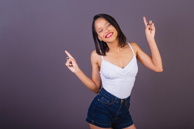 Young adult woman from northeastern brazil dancing and partying