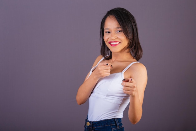 Young adult woman from northeastern brazil Pointing at camera choosing you you choose