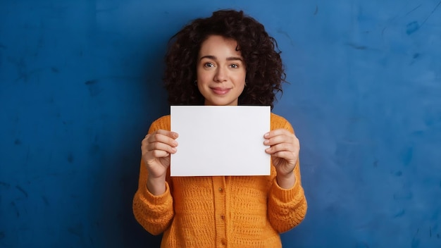 Photo young adult woman holding empty paper card for sign or symbol