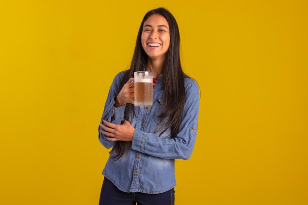 Young adult woman in studio photos making facial expressions and holding a glass of beer