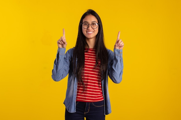 Young adult woman in studio shots making facial expressions and using fingers and hands