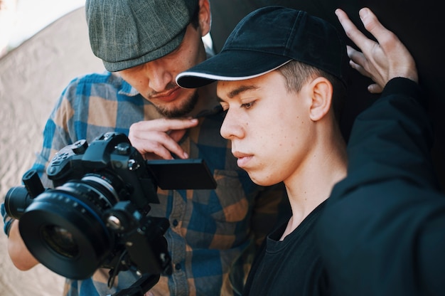 Young adults operator and director shoots on camera. concentrated sights on viewfinder