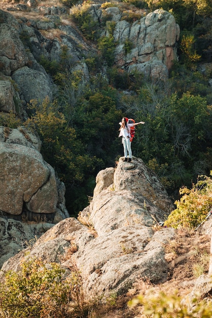 Young adventurous woman near the canyon