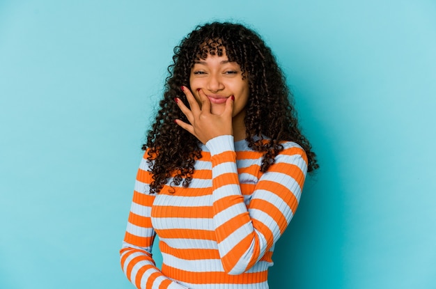 Young african american afro woman isolated doubting between two options.