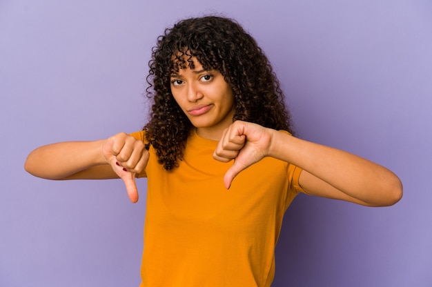 Young african american afro woman isolated showing thumb down, disappointment concept.