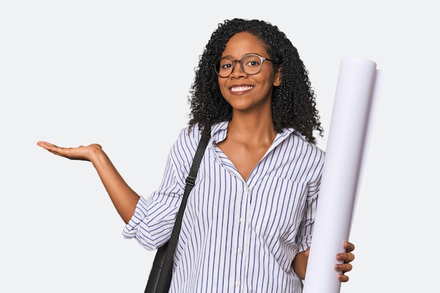 Young African American architect with blueprint showing a copy space on a palm