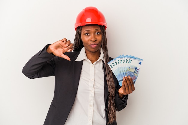 Young african american architect woman holding bills isolated on white background showing a dislike gesture, thumbs down. Disagreement concept.