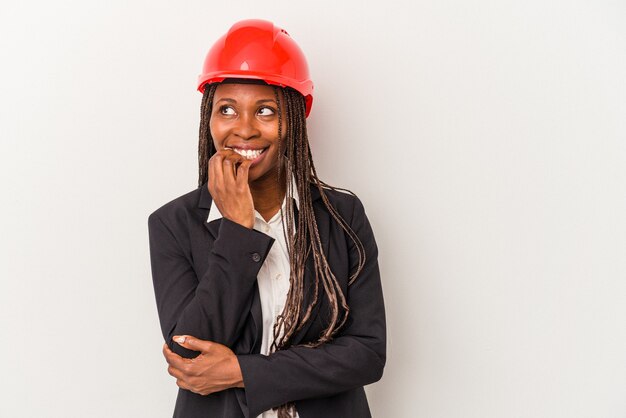 Young african american architect woman isolated on white background relaxed thinking about something looking at a copy space.