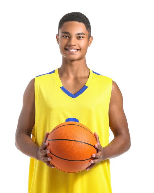 Young African-American basketball player on white surface