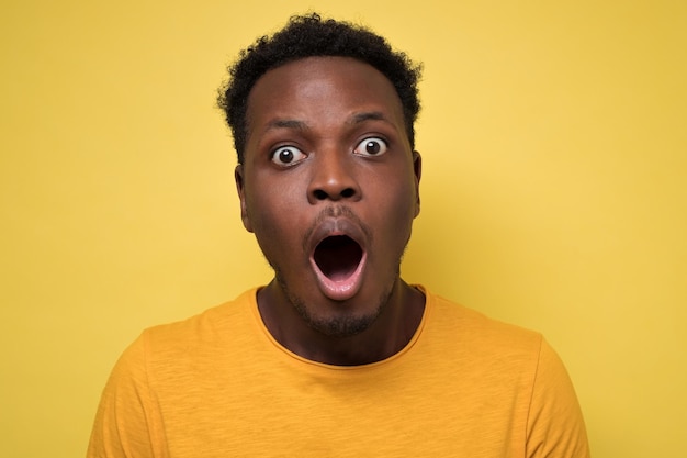 Young african american black man surprised face expression