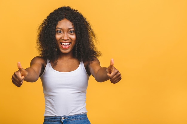 Young African American black woman giving a thumbs-up gesture.