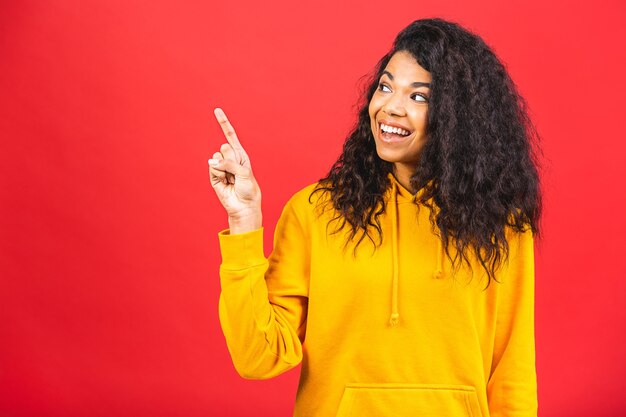 young african american black woman poiting finger isolated over red background