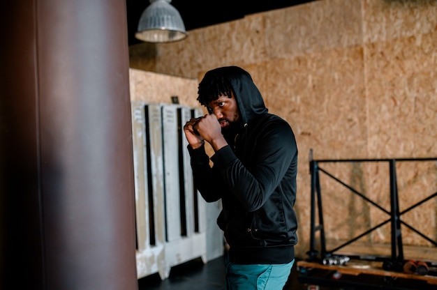 Young African American Boxer working out at a gym