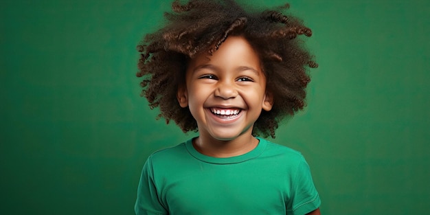 Young African American boy is smiling on green studio background