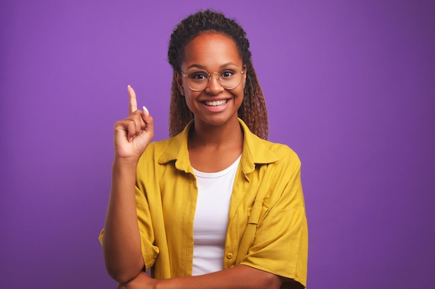 Young African American business woman shows finger up by coming up with new idea