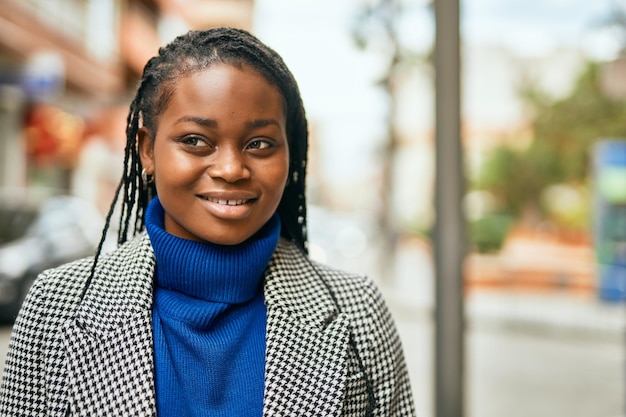 Young african american businesswoman smiling happy standing at the city.