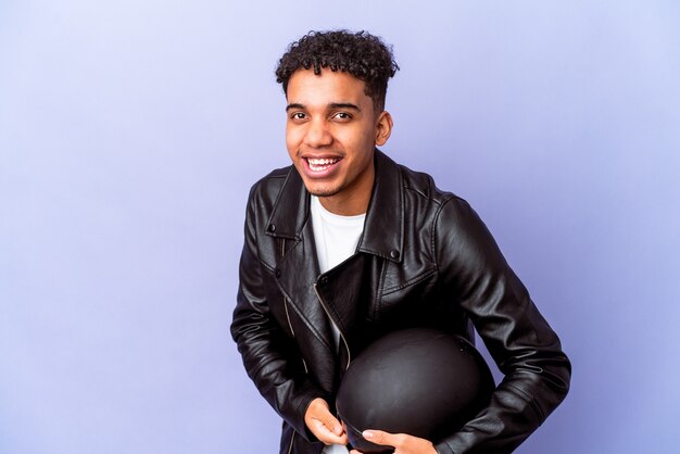 Young african american curly biker man isolated laughing and having fun.