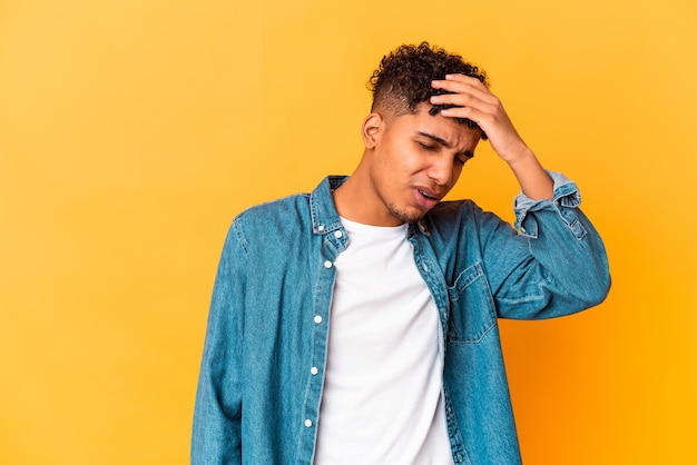 Young african american curly man isolated on purple touching temples and having headache.