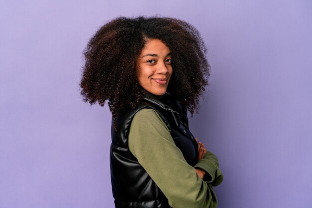 Young african american curly woman isolated on purple wall happy, smiling and cheerful.