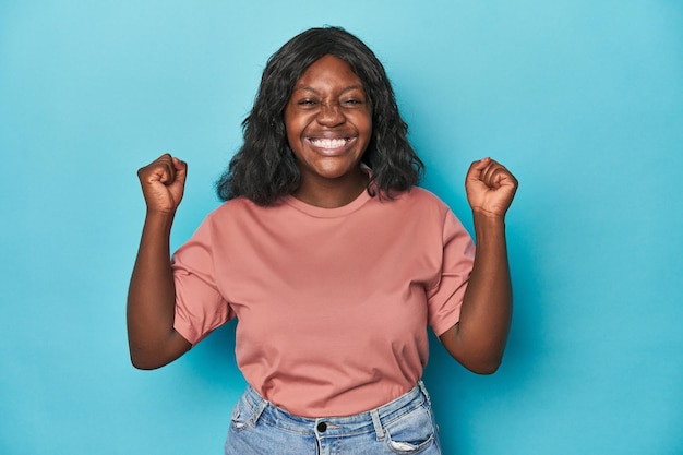 Young african american curvy woman celebrating a victory passion and enthusiasm happy expression