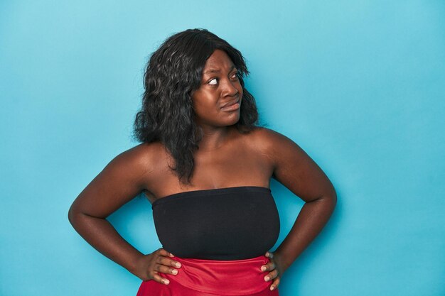 Young african american curvy woman confused feels doubtful and unsure