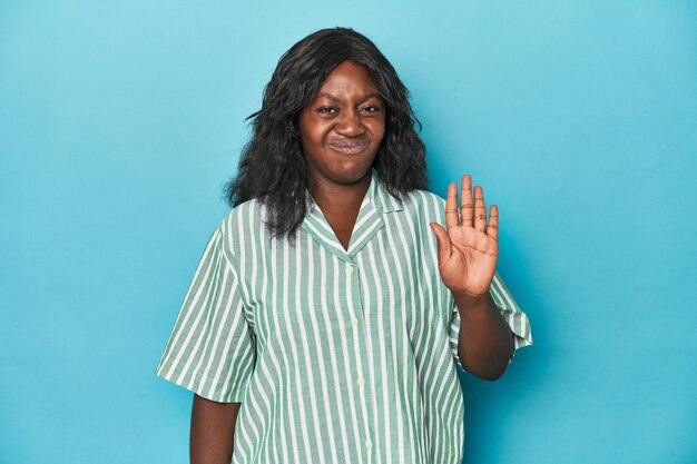 Young african american curvy woman smiling cheerful showing number five with fingers