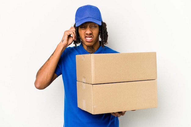 Young African American delivery man isolated on white background covering ears with hands