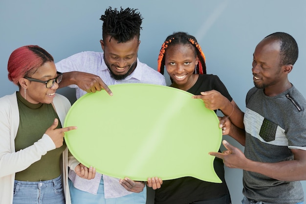 Young african american friends holding up copyspace placard thought bubbles