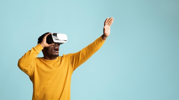 Young african american guy using vr glasses