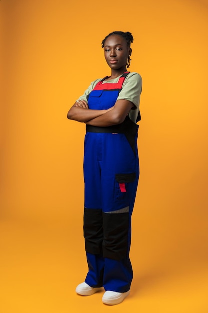 Young african american handywoman in yellow studio