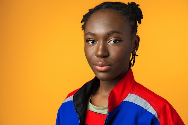 Young african american handywoman in yellow studio