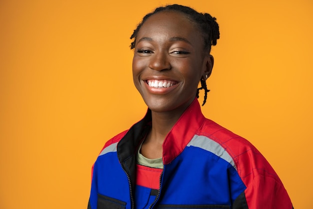 Young african american handywoman in yellow studio