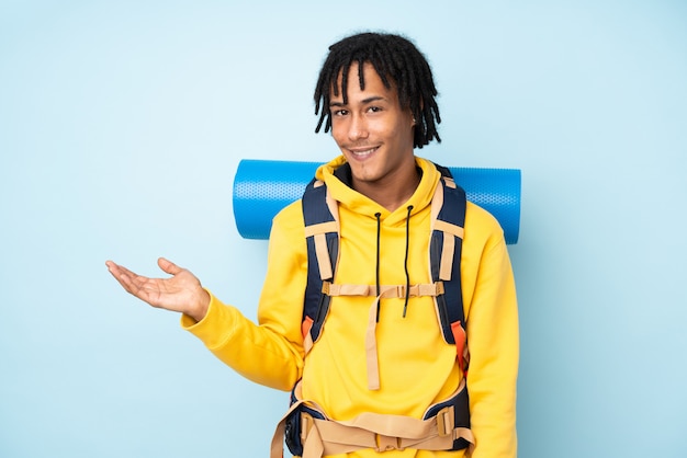 Young African American hiker man over wall