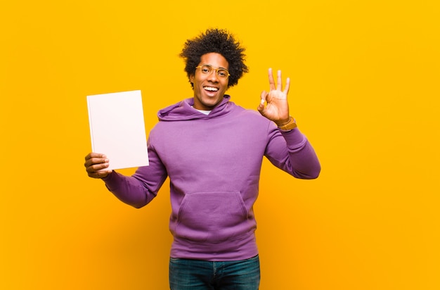 Young african american man  against orange 