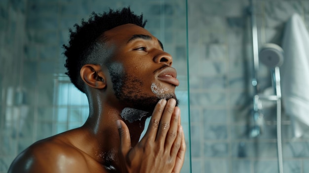 Photo young african american man applying shaving foam in the shower