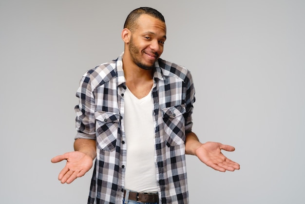 Young African-American man over gray background