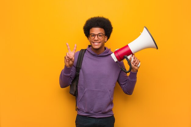 Young african american man holding a megaphone