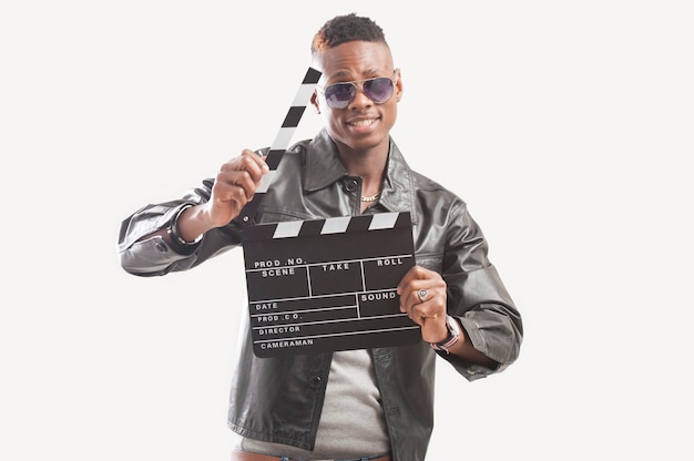 Young african american man holding video film clapboard