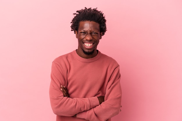 Young african american man isolated on pink background laughing and having fun.